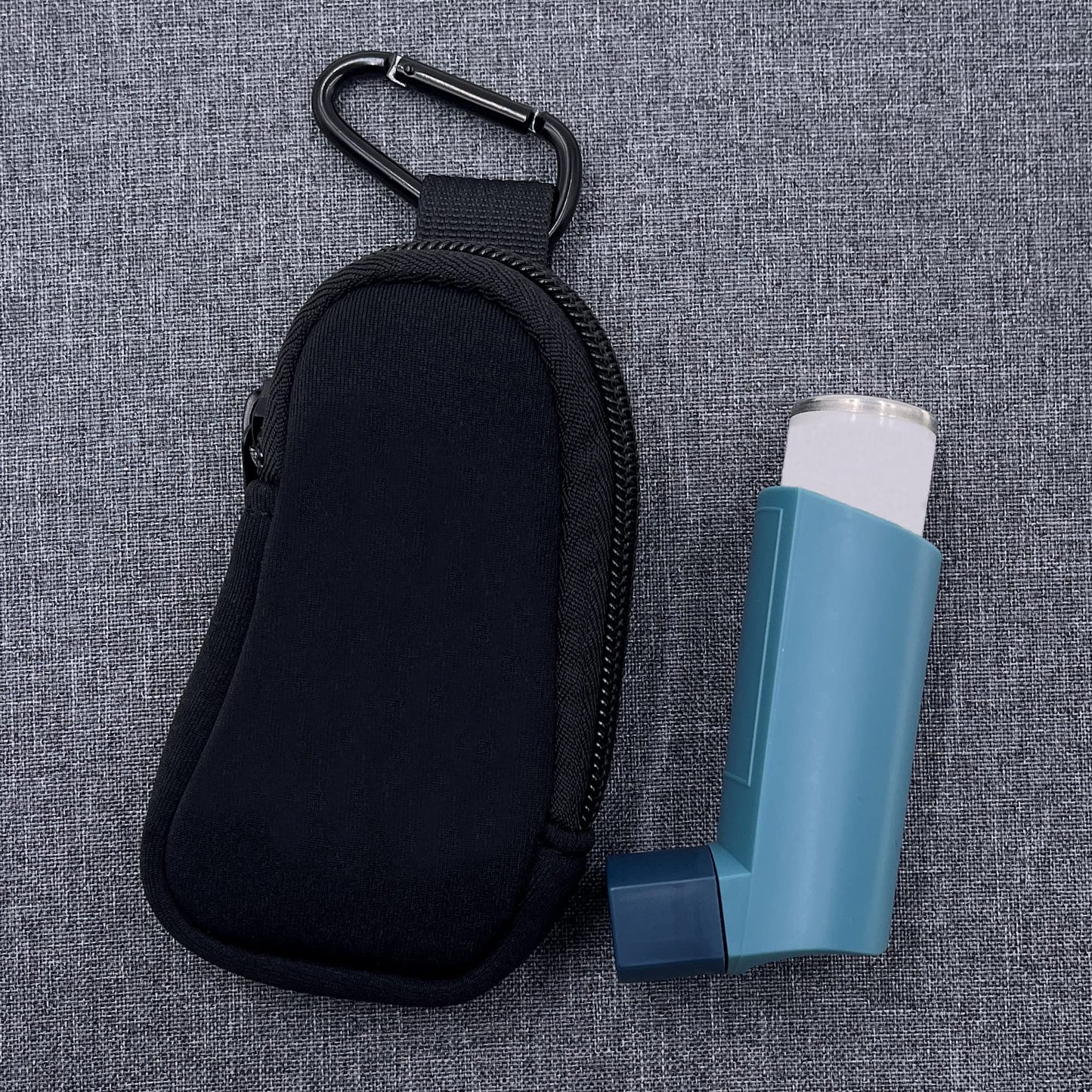 Black neoprene medicine storage pouch showing secure zipper closure and D ring