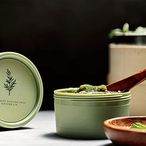 Self-heating wash-off mask jar next to its protective box container on a clean surface.