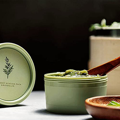 Self-heating wash-off mask jar next to its protective box container on a clean surface.