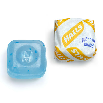 Close up view of individual HALLS Mentho Lyptus wrapped cough drops