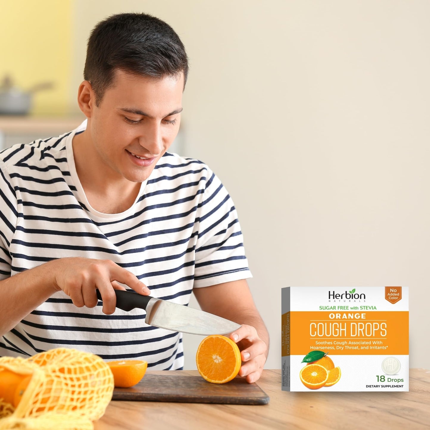 Authentic imported Herbion Naturals orange cough drops box displaying the menthol oral anesthetic properties.