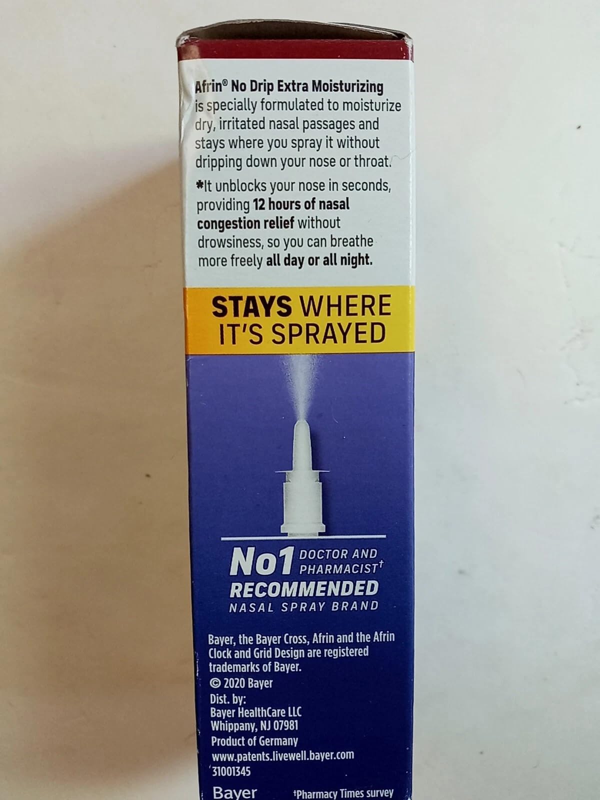 Side view of Afrin No Drip non-drowsy decongestant spray bottle.