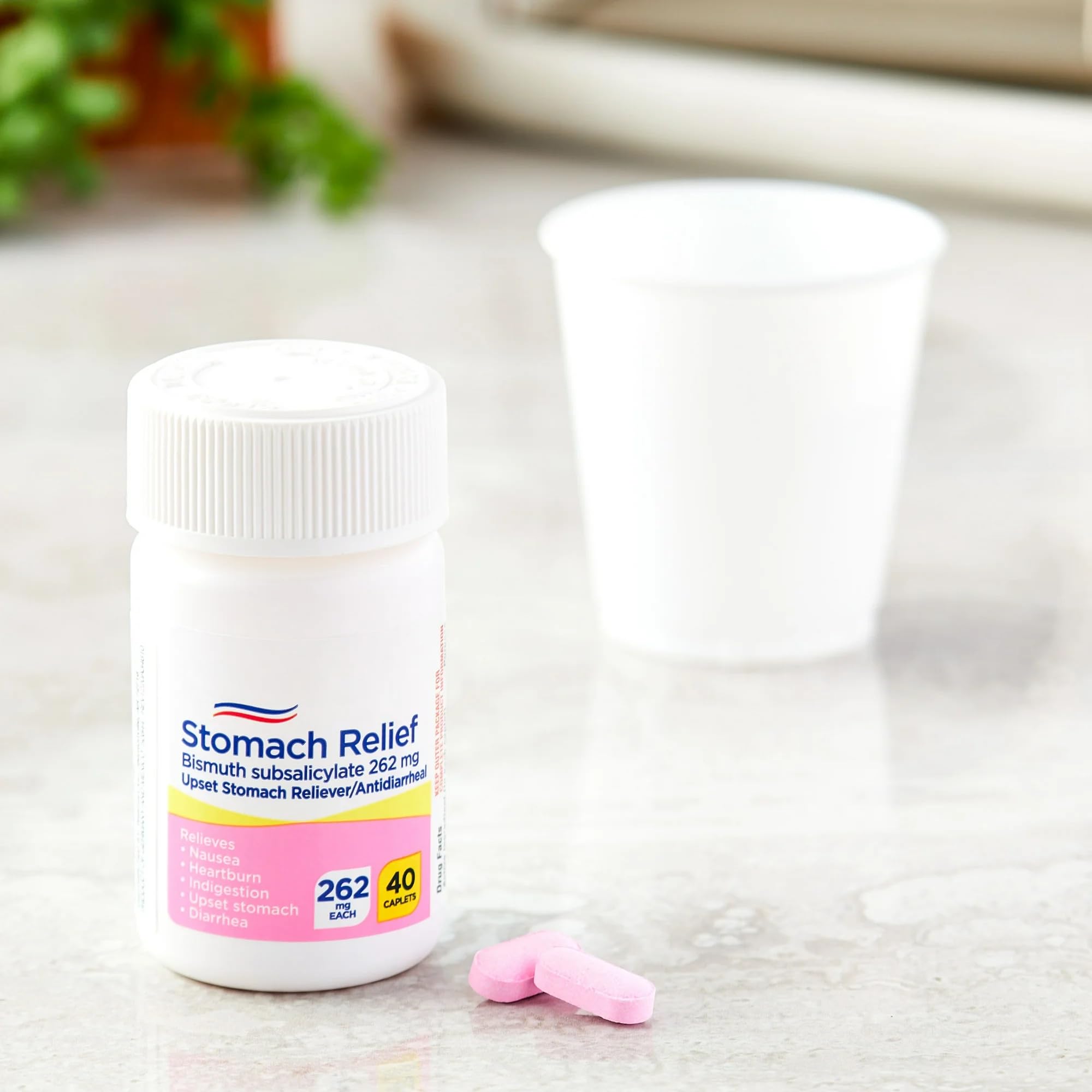 Equate pink bismuth subsalicylate tablets package showing multi symptom upset stomach relief details