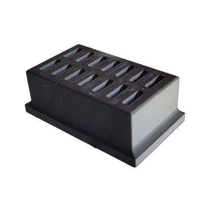 Compact black 3D printed eye drop storage tray placed on a clean counter space