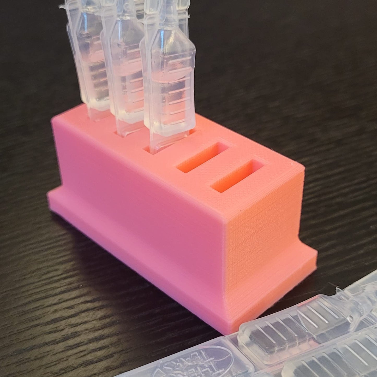 Close up view of the wider slot spacing designed for thicker disposable eye medicine tubes