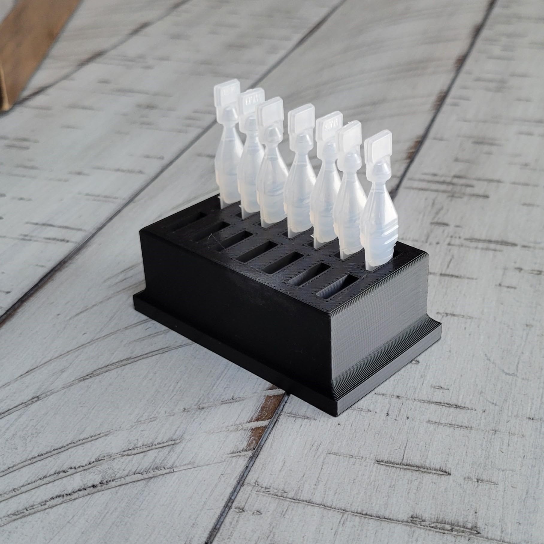 Premium USA imported single use eye drop vial organizer stored inside a refrigerator shelf