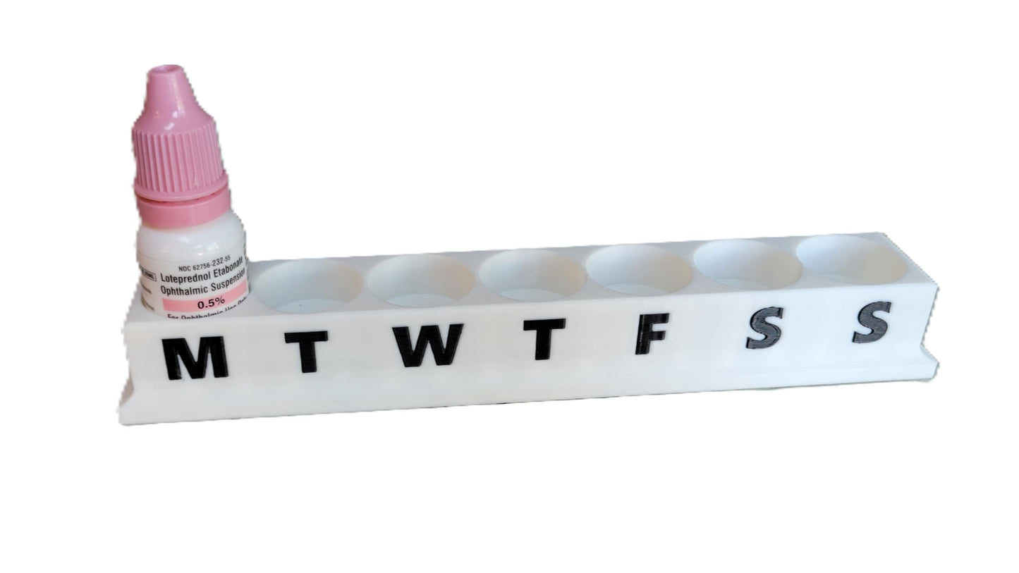 Top down view of the six slot upright eye care bottle holder showing slot spacing and design.
