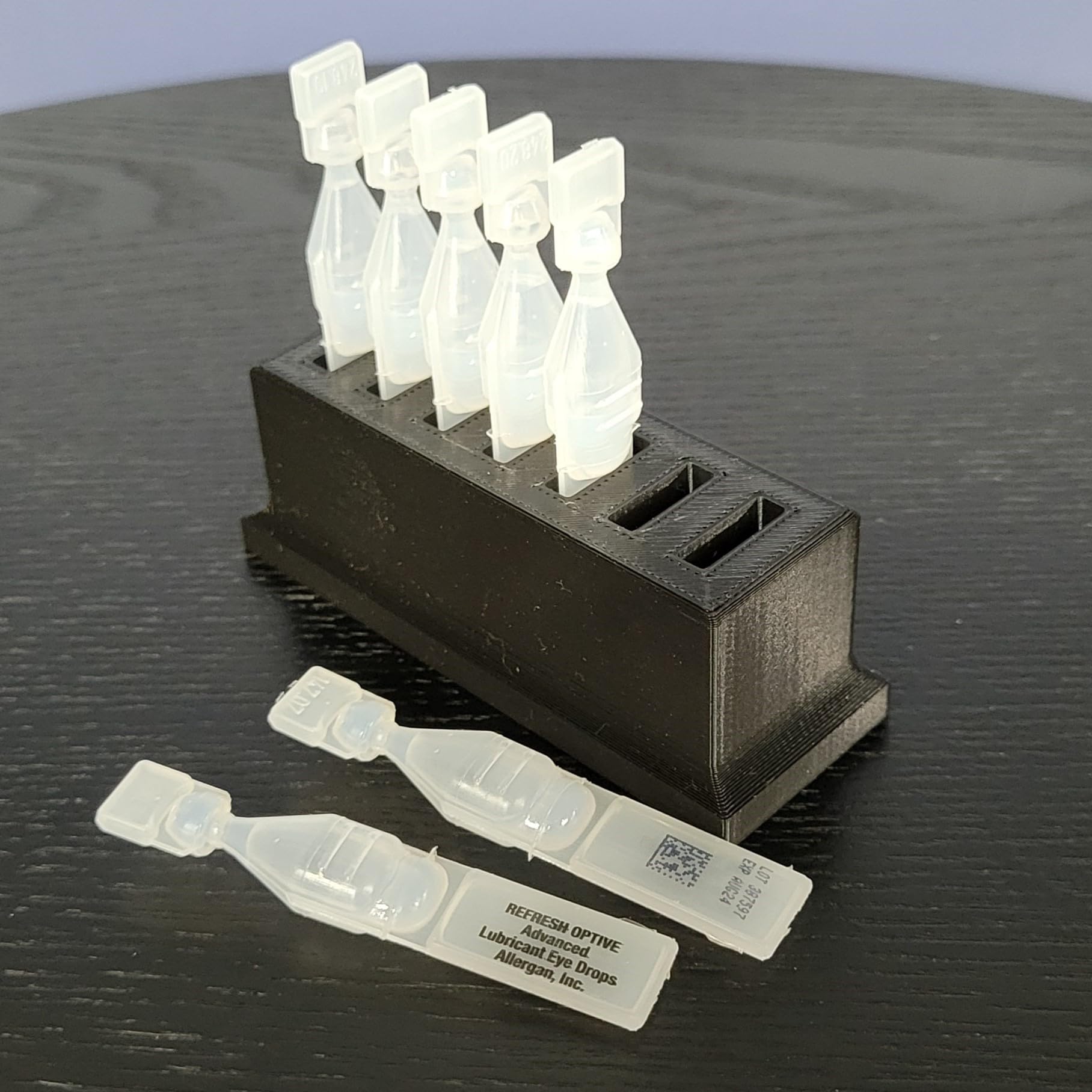 Top down perspective of the upgraded wide spacing slots on the Znet3D single use vial holder.