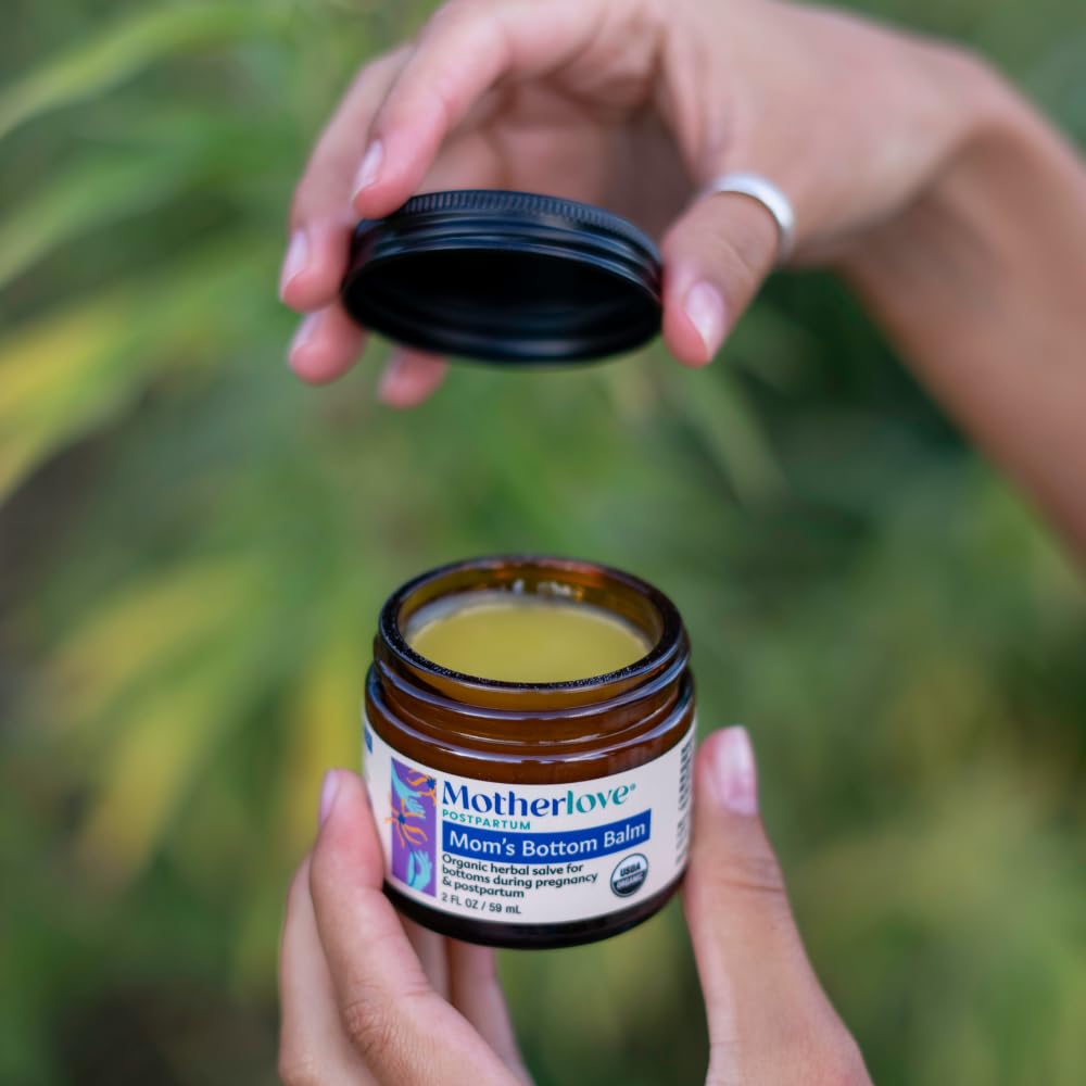 Motherlove postpartum care bottom balm jar placement highlighting non-GMO and cruelty-free labels.
