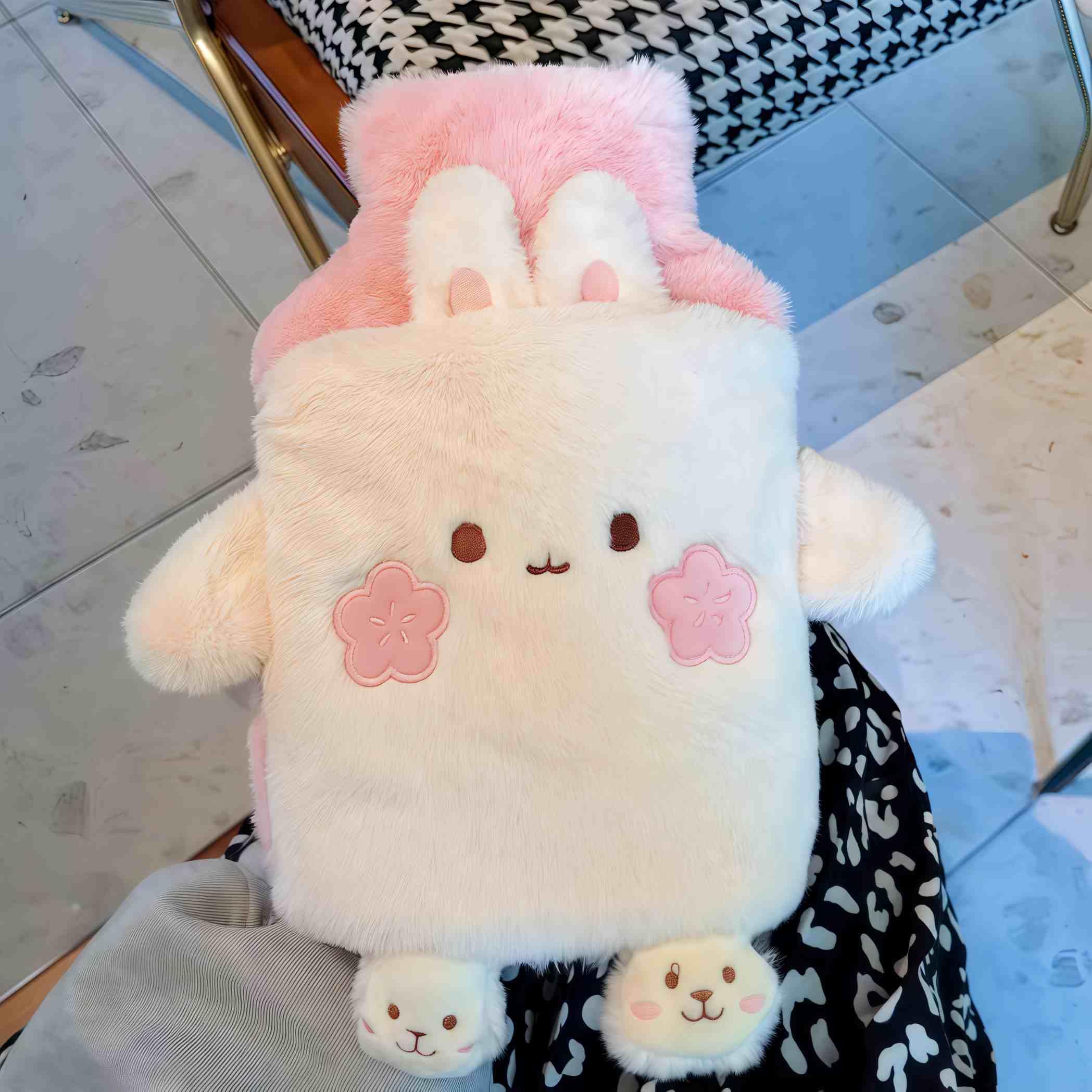 Winatehr plush hot water bag displaying the integrated hand warmer pocket design