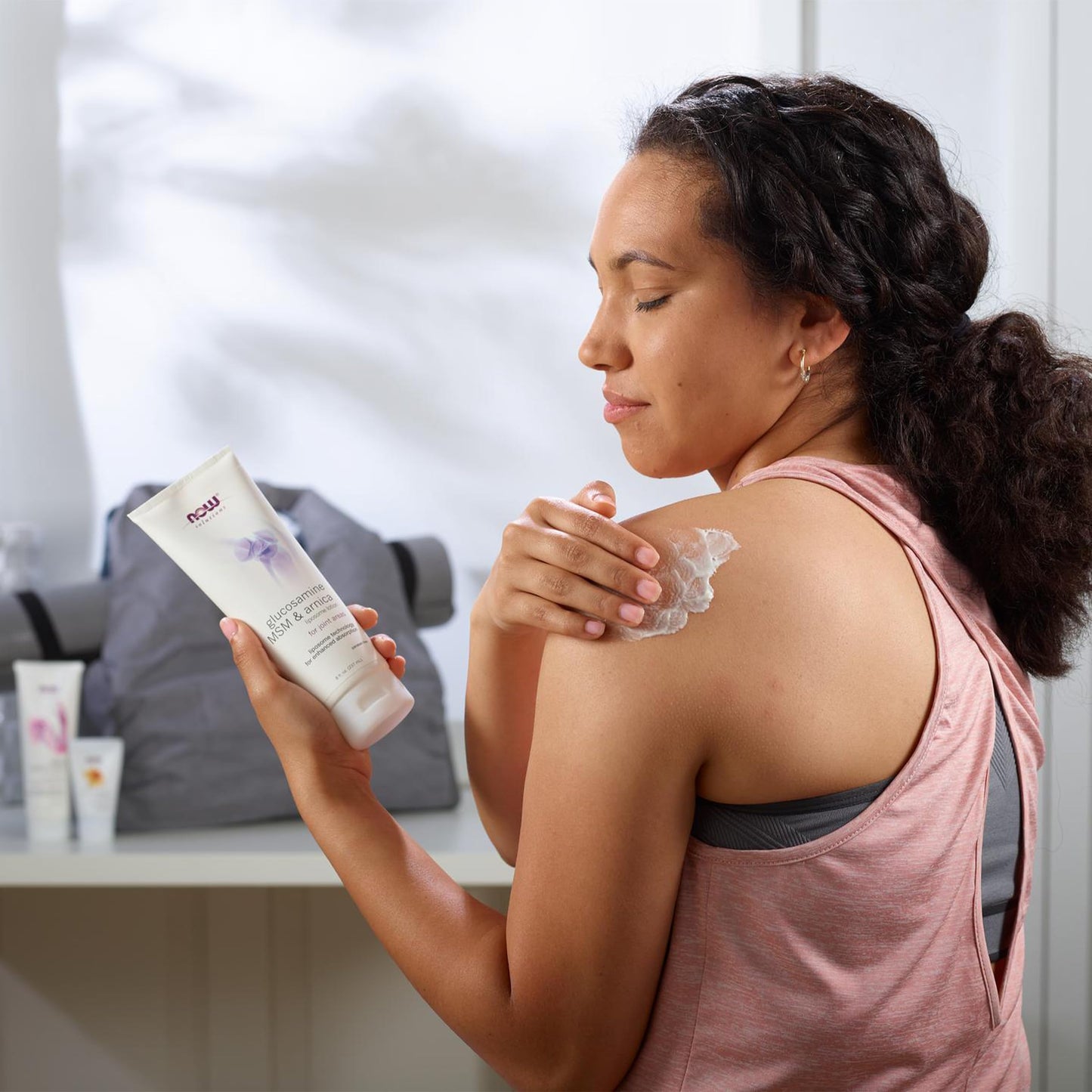 Back view of Now Foods Glucosamine MSM and Arnica topical lotion with directions of use.