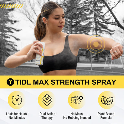 Athlete using TIDL recovery spray on shoulder