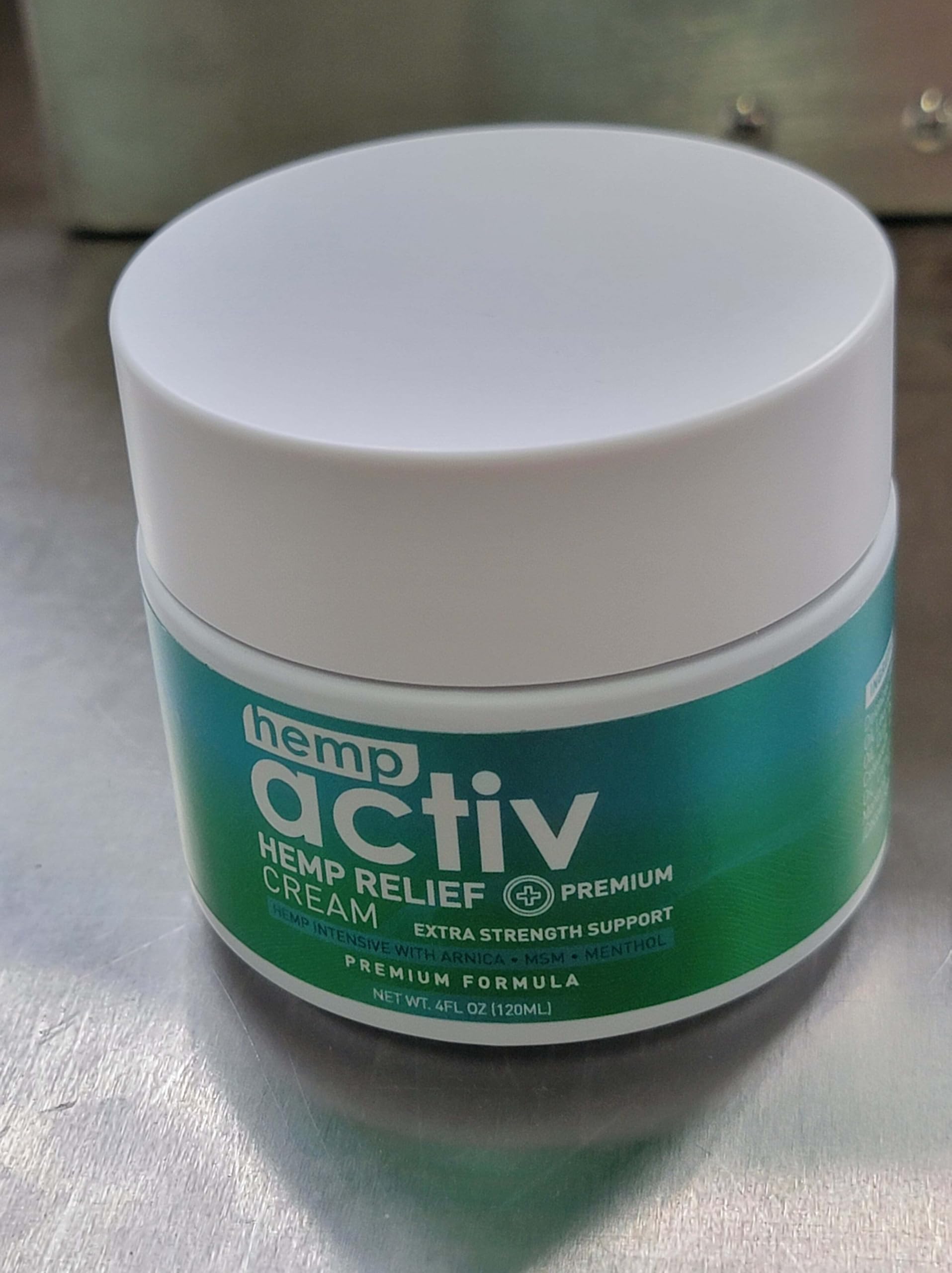 Person applying Hempactiv cooling cream on shoulder