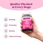 BeLive PMS Support Gummies bottle next to a glass of water