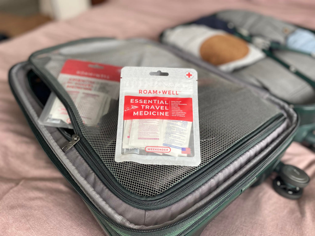 Roamwell Weekender portable medical pouch showing twelve in one symptom relief tablet selection.