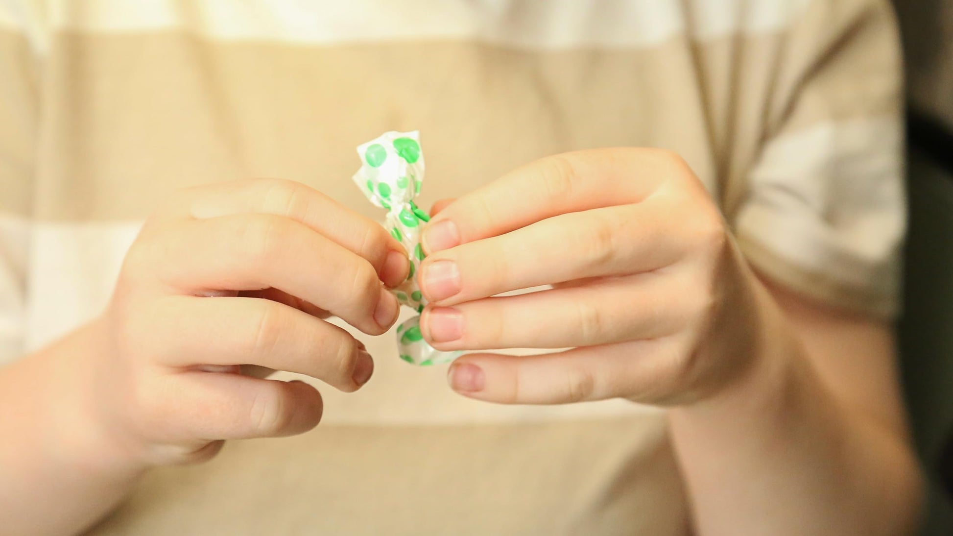Close-up of a single wrapped Tummy Drops Peppermint lozenge highlighting travel-friendly convenience.