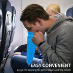 Cloudberg medical grade nausea bags folded compactly next to a travel backpack.