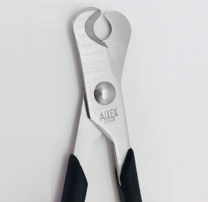ALLEX small pill splitter scissors being held to demonstrate the ambidextrous handle design for caregivers.