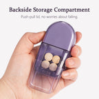 ColeMela travel pill splitter with the integrated cleaning brush detached from its slot.