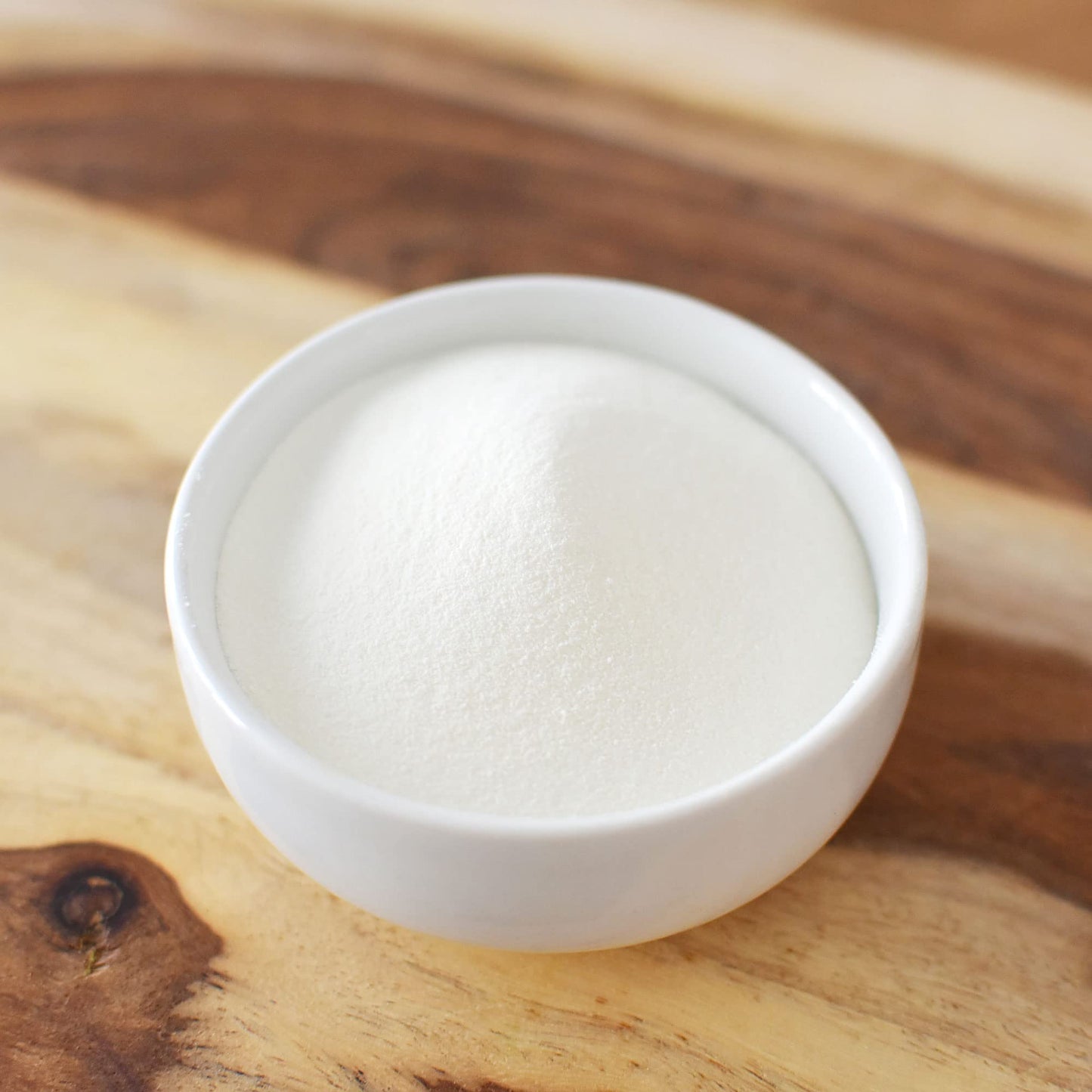 Paleo friendly collagen powder container showcasing batch tested purity verification marks.
