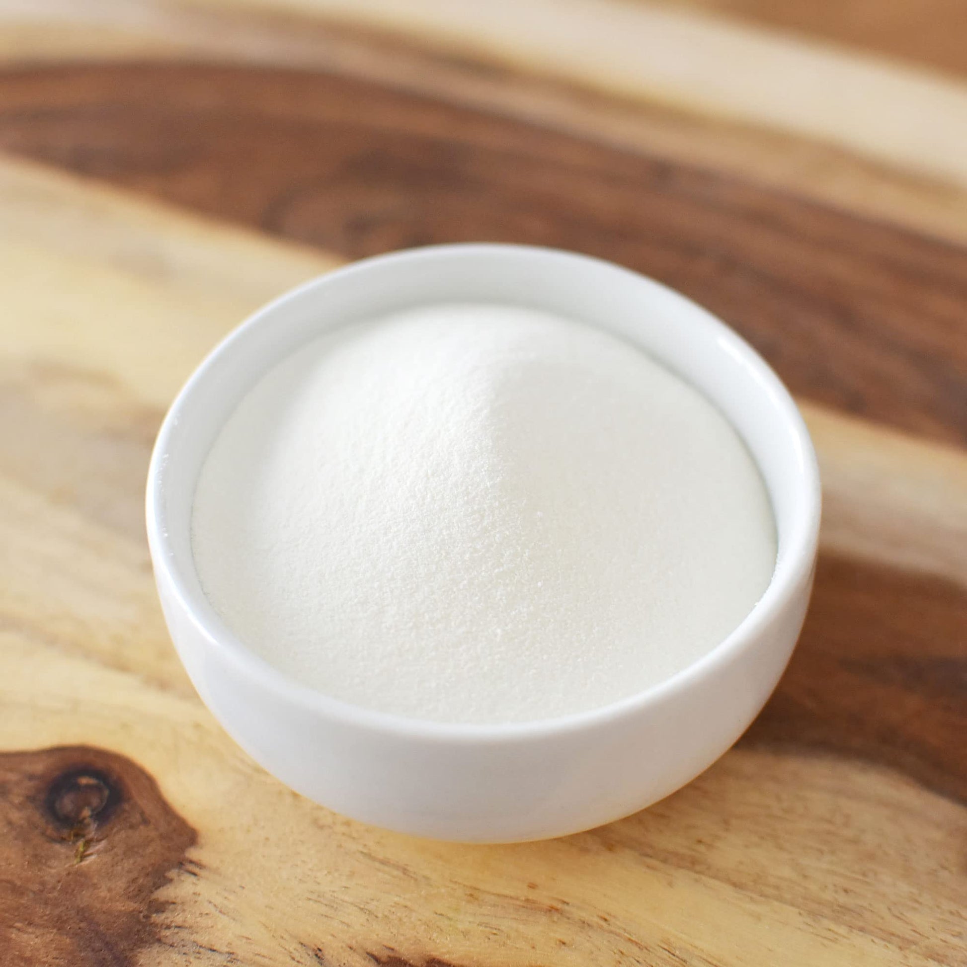 Paleo friendly collagen powder container showcasing batch tested purity verification marks.