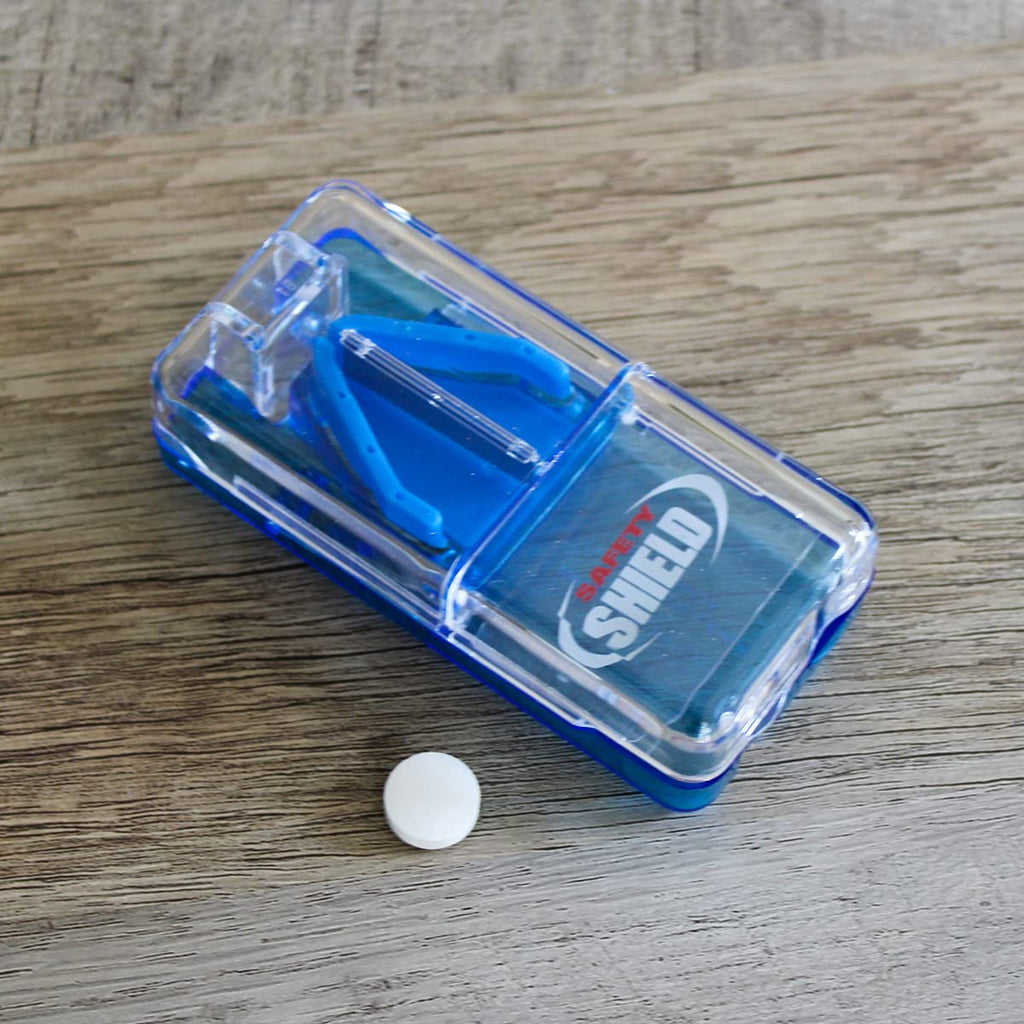 Ezy Dose health management device showing a vitamin tablet aligned perfectly inside the cutting track