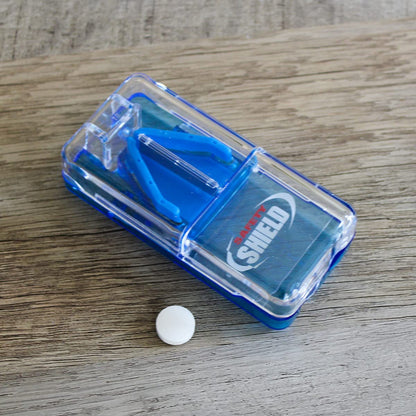 Ezy Dose health management device showing a vitamin tablet aligned perfectly inside the cutting track