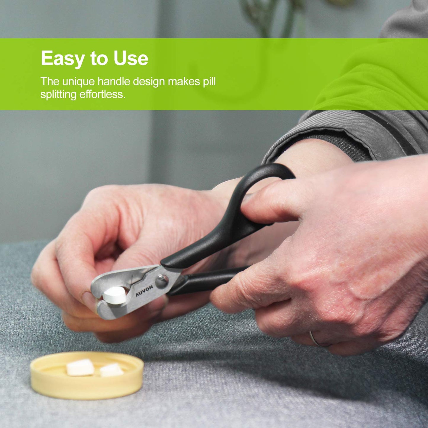 Ergonomic medication cutter being washed under running water for easy cleaning