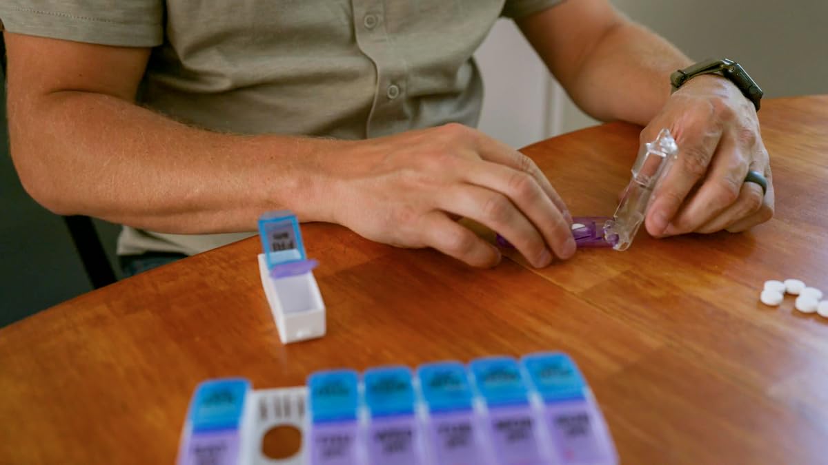 EZY DOSE ergonomic pill cutter being closed to easily split a vitamin tablet in half