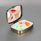 Dynippy compact travel pill container held in hand to illustrate pocket and purse sizing dimensions.