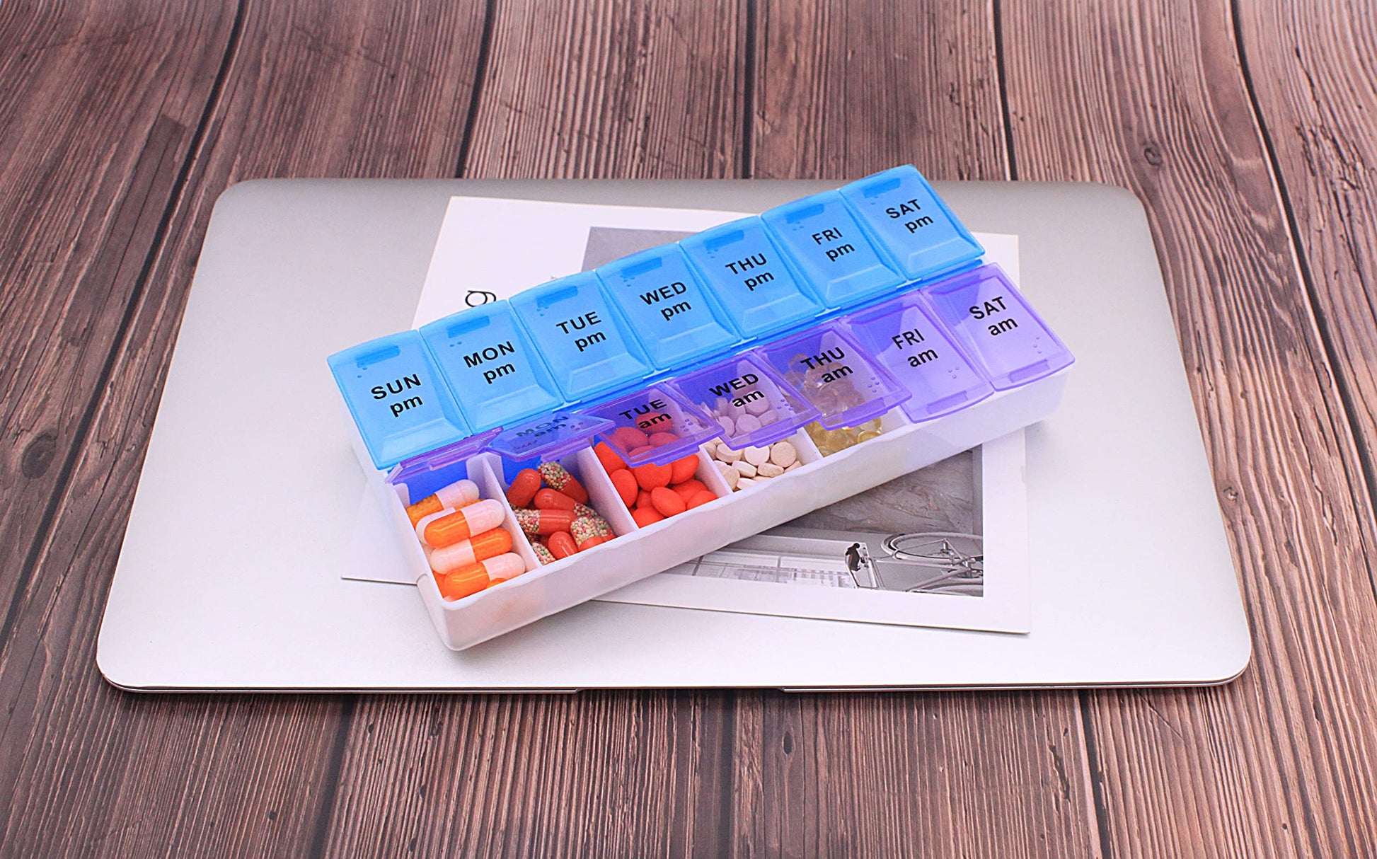 Translucent daily medicine planner highlighting the clear day labels from Sunday through Saturday.