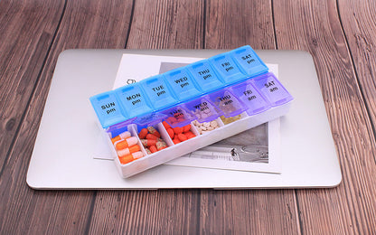 Translucent daily medicine planner highlighting the clear day labels from Sunday through Saturday.