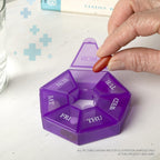 Compact travel vitamin container by Deke Home held in hand to show size