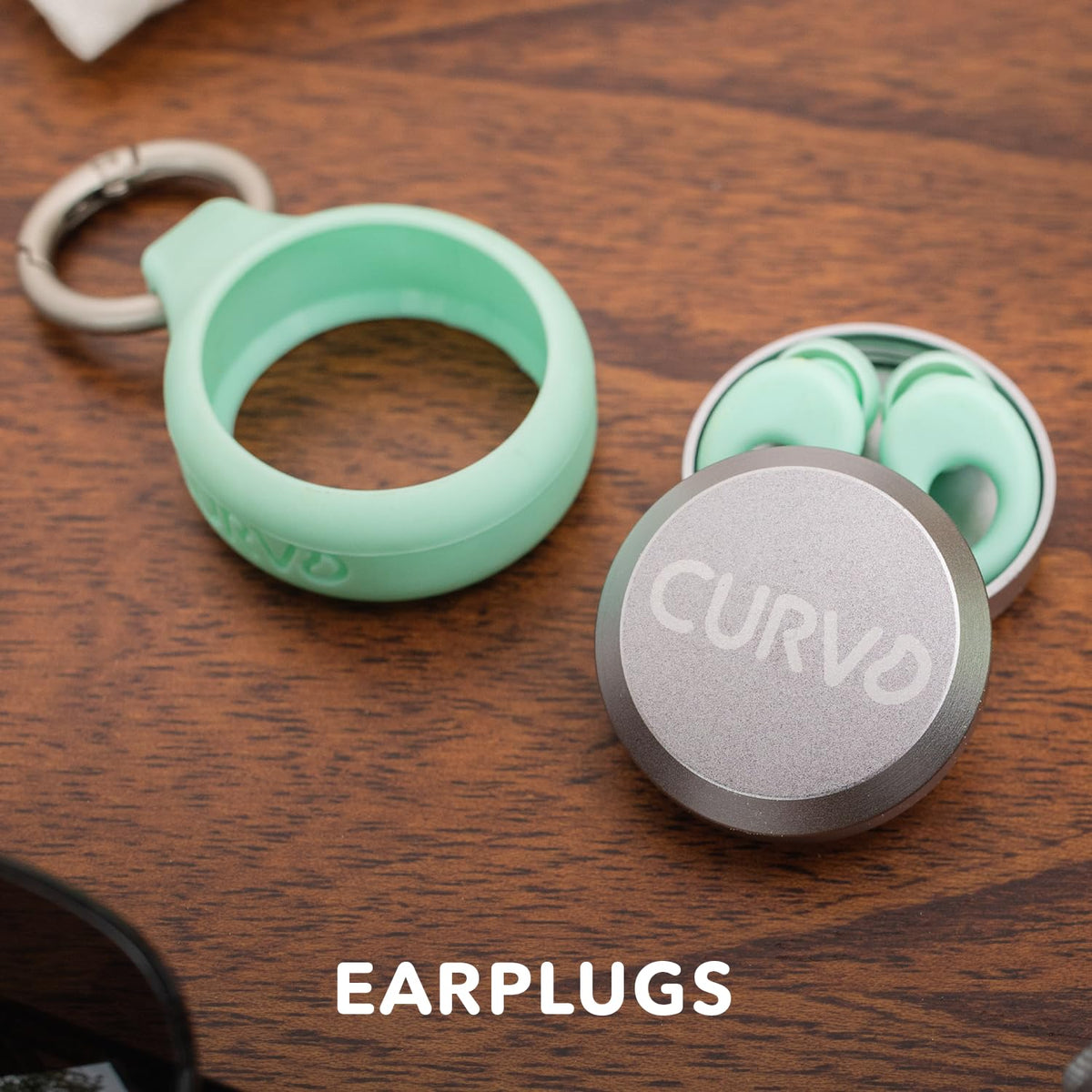 CURVD small waterproof holder storing premium earplugs securely on a metal key ring