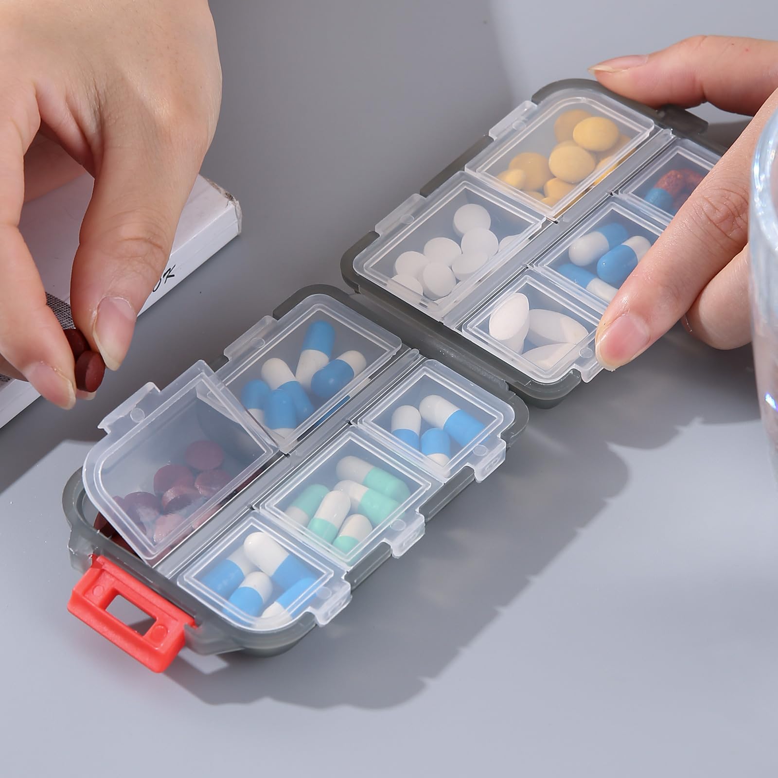 Zuihug travel medicine box held in hand demonstrating small lightweight scale