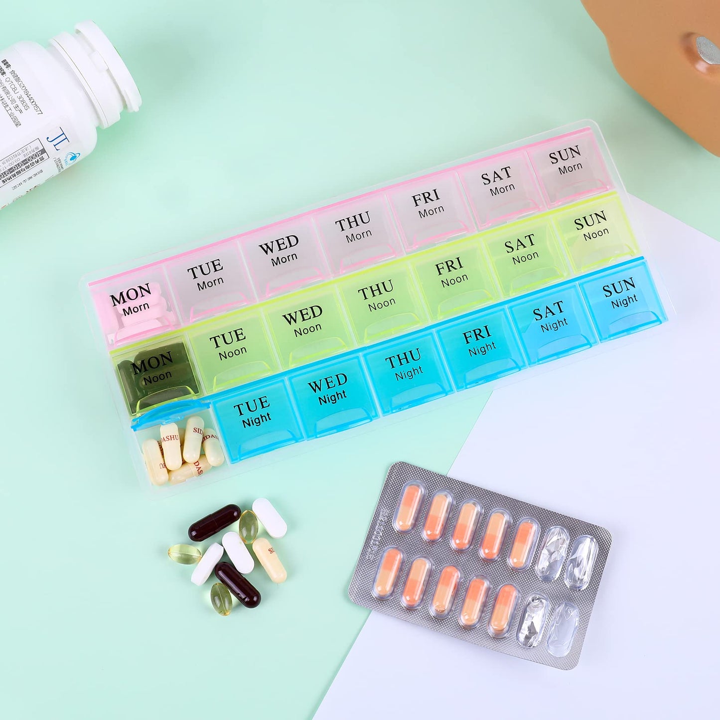 Teikou moisture-resistant weekly pill storage box emphasizing clear bold day and time lettering.