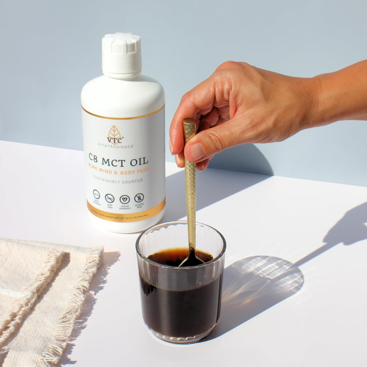 VTC MCT oil mixed into morning coffee cup