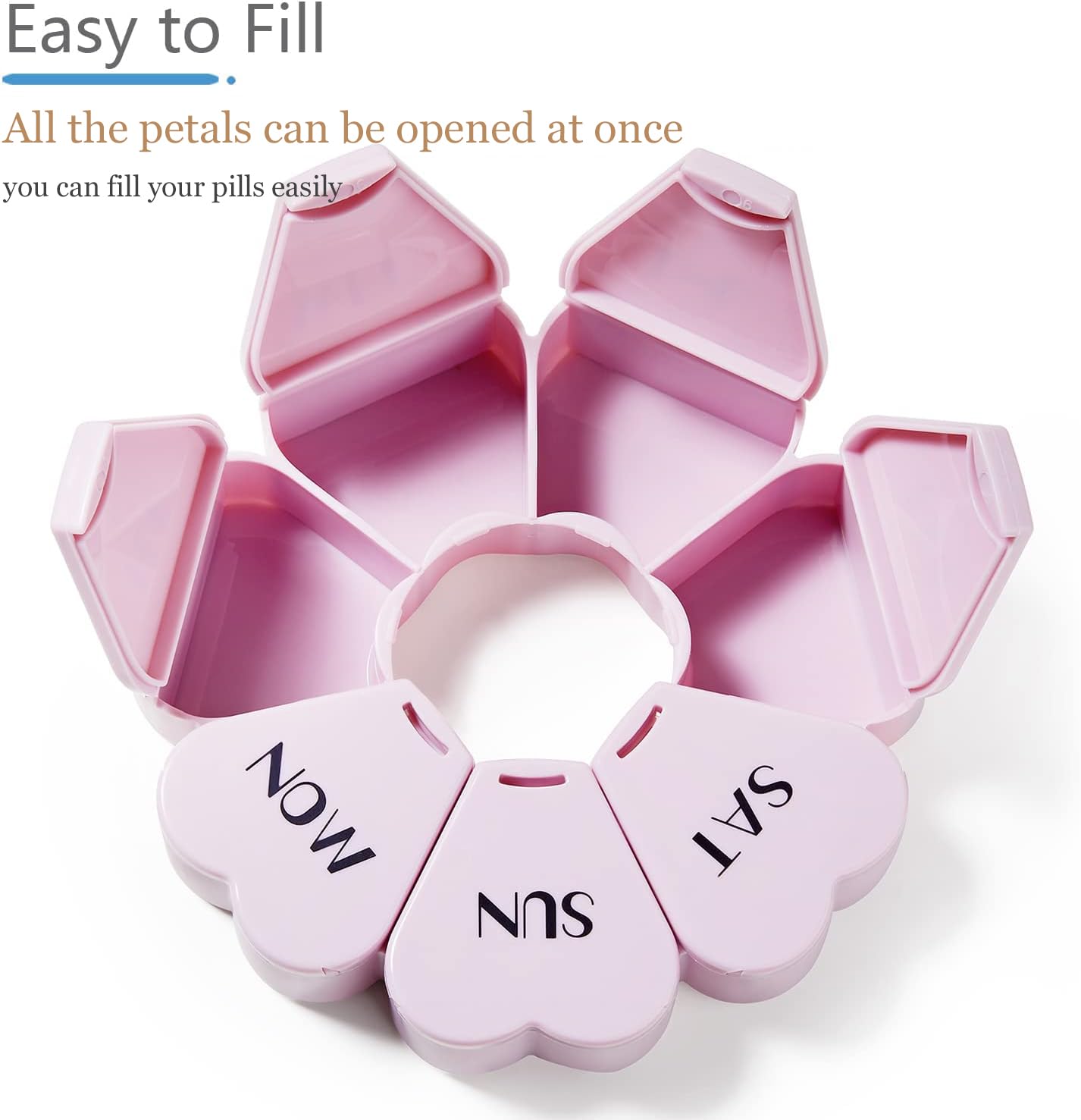 Compact heart shaped girly pill box held in hand to showcase portable size.