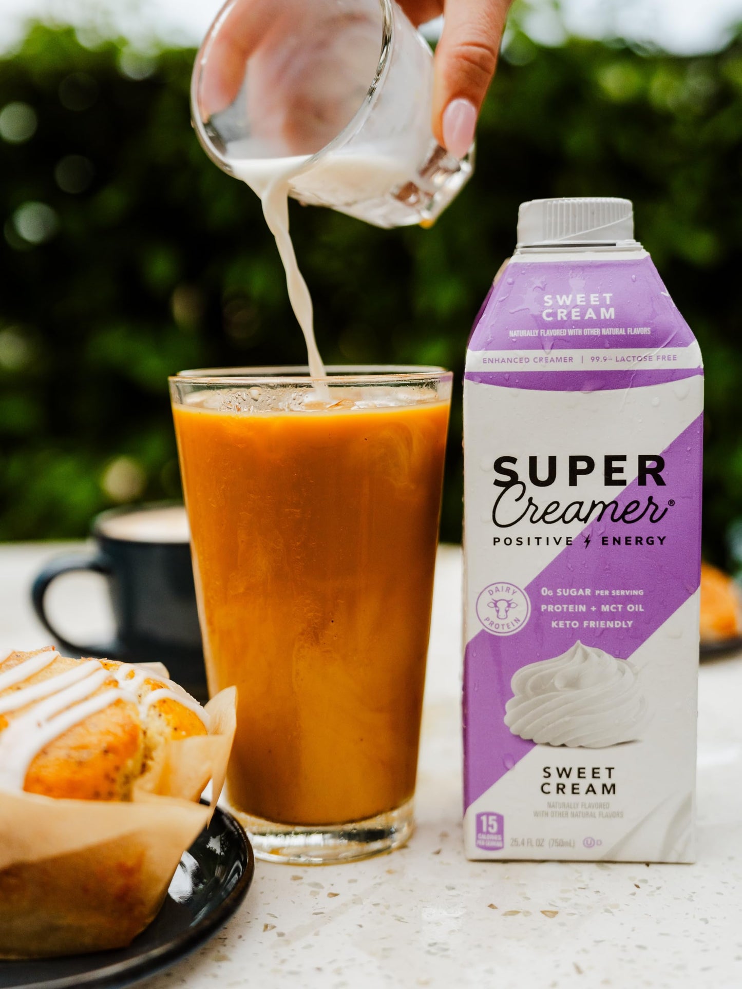 Close up view of the liquid creamer texture showing its smooth and creamy consistency next to coffee beans