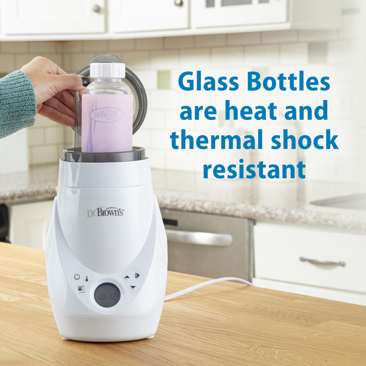 Assembled internal green vent system inside a 250 mL glass infant feeding bottle for colic reduction