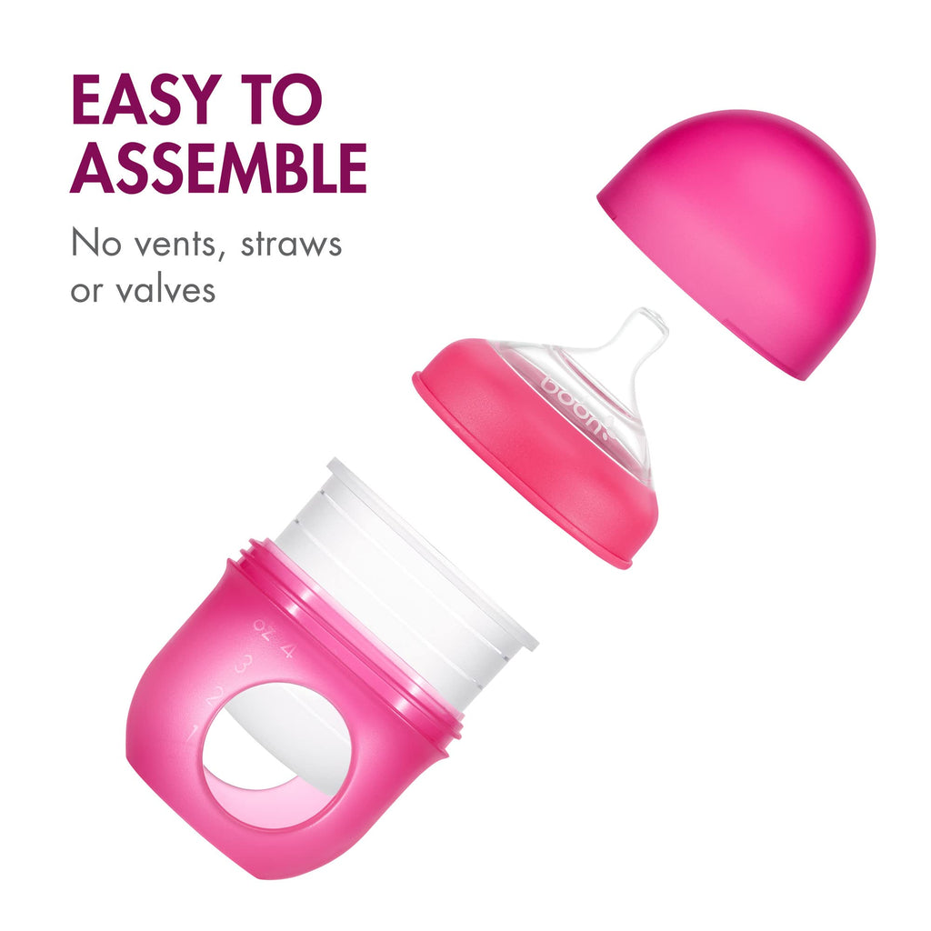 Side view of Boon Nursh 4 ounce pink baby bottle