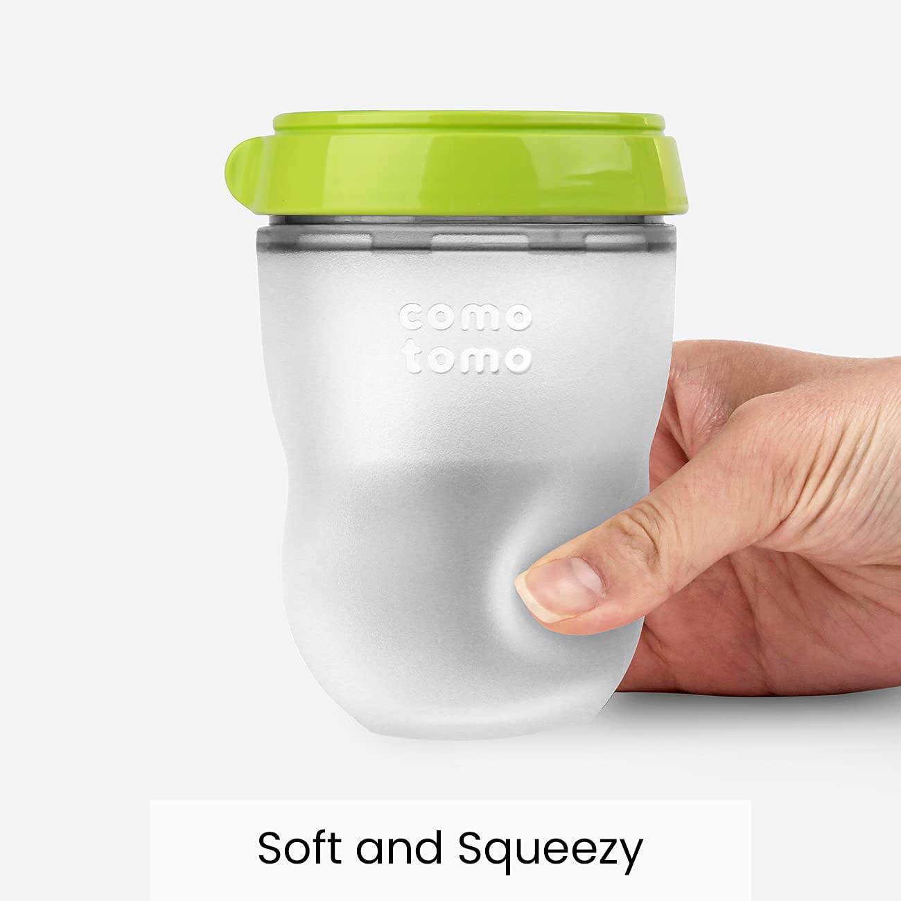 Side profile of Comotomo green baby bottle demonstrating squeezable silicone