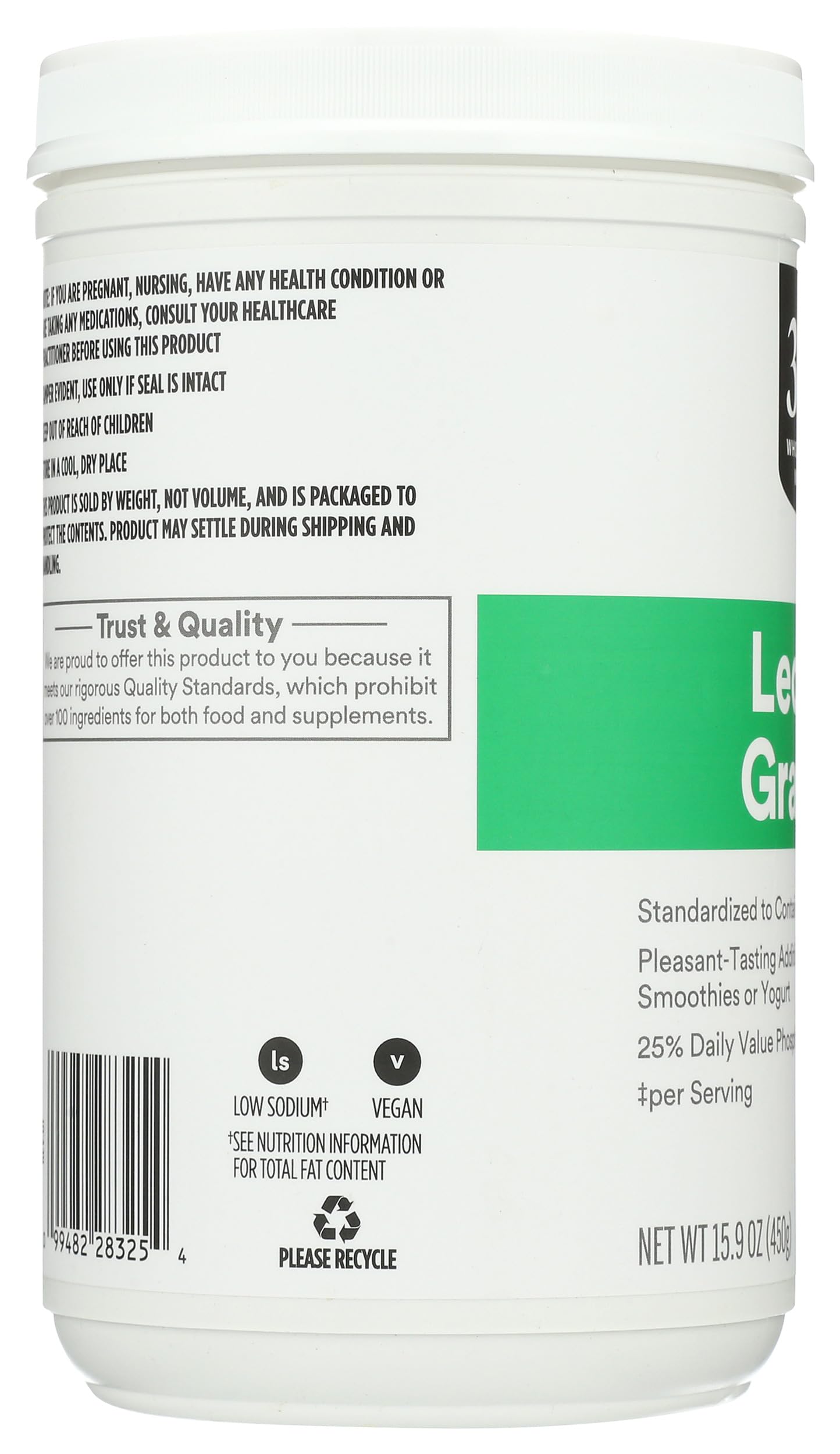 Spoon pouring non GMO soy lecithin granules over a breakfast smoothie bowl