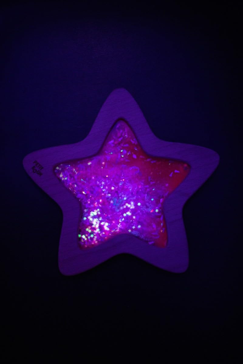 Child playing with Petit Boum Nebula sensory star