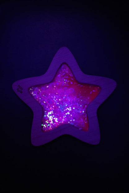 Child playing with Petit Boum Nebula sensory star