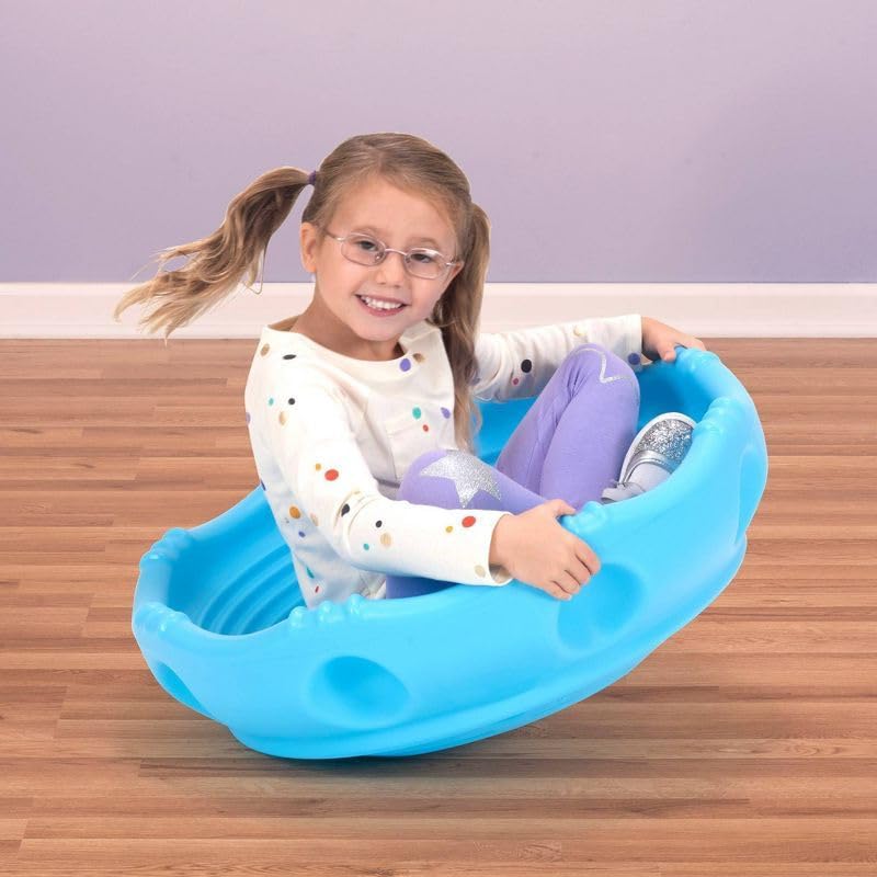 Toddler sitting on Simplay3 blue wobble disk