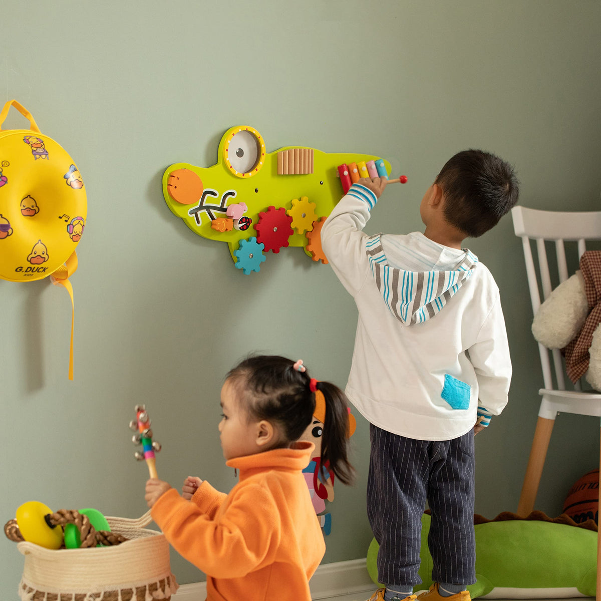 Close-up of spinning gears and interactive elements on the Montessori wall toy