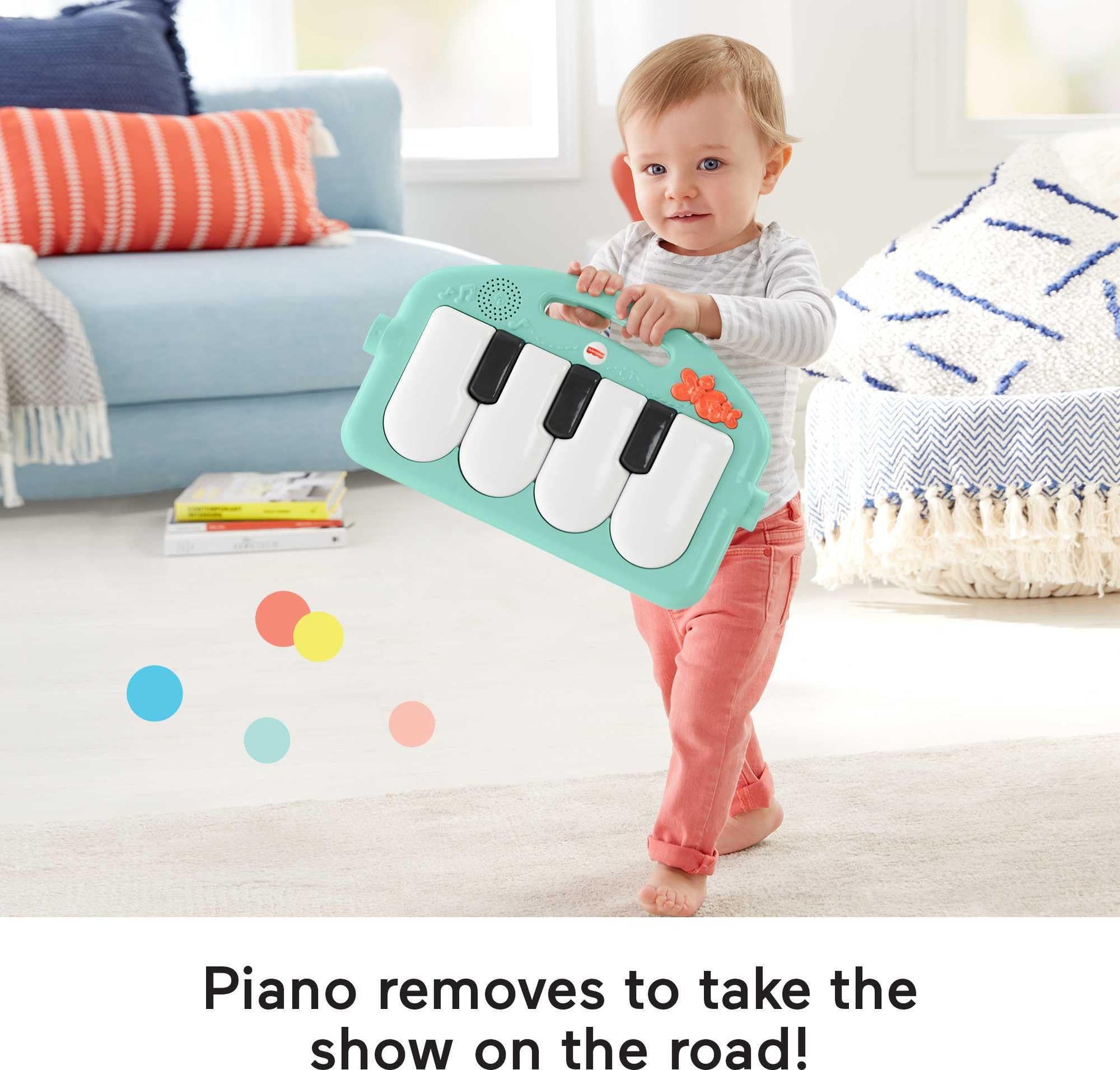 Toddler sitting and playing with the Fisher-Price musical piano