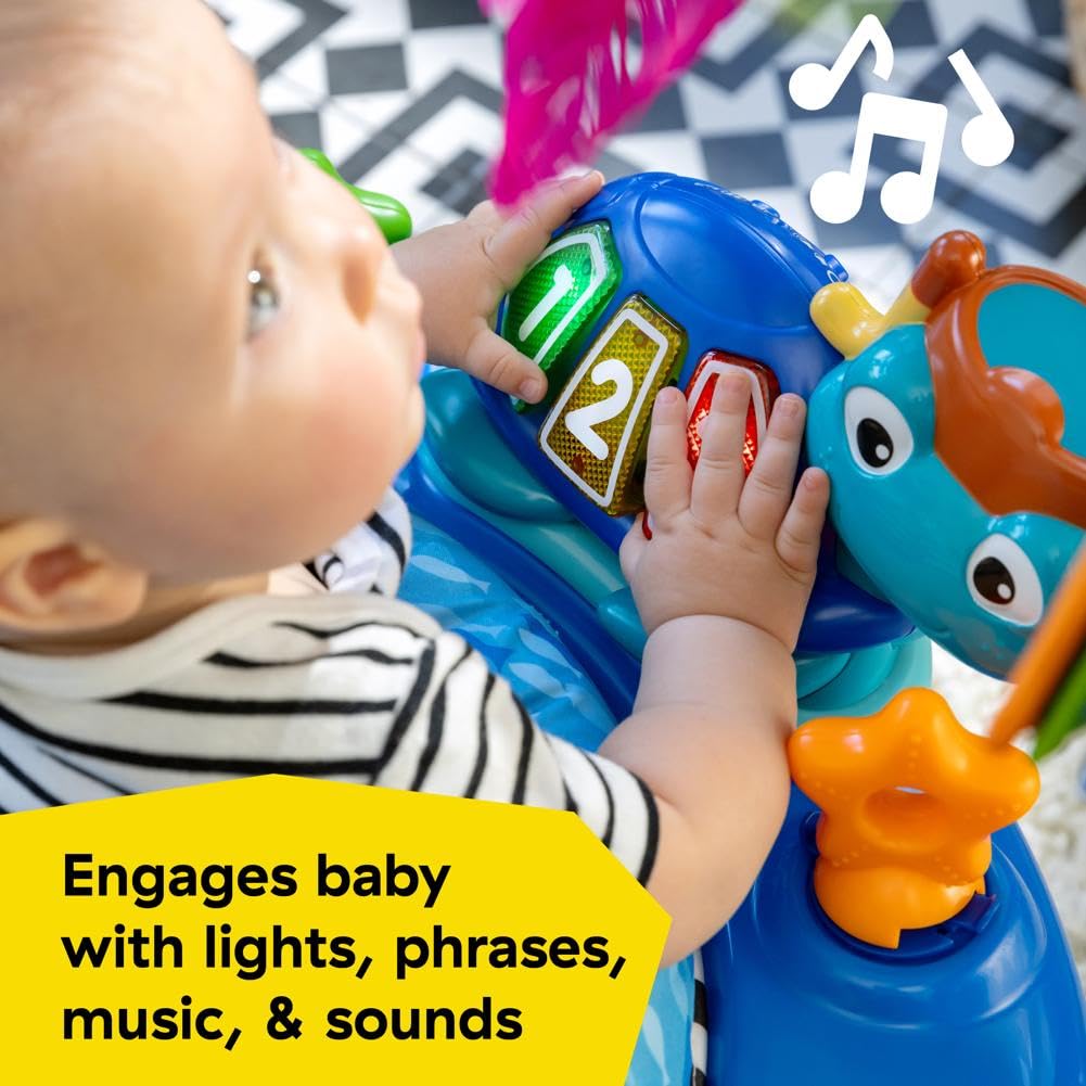 Baby using ocean-themed sensory toys in activity center