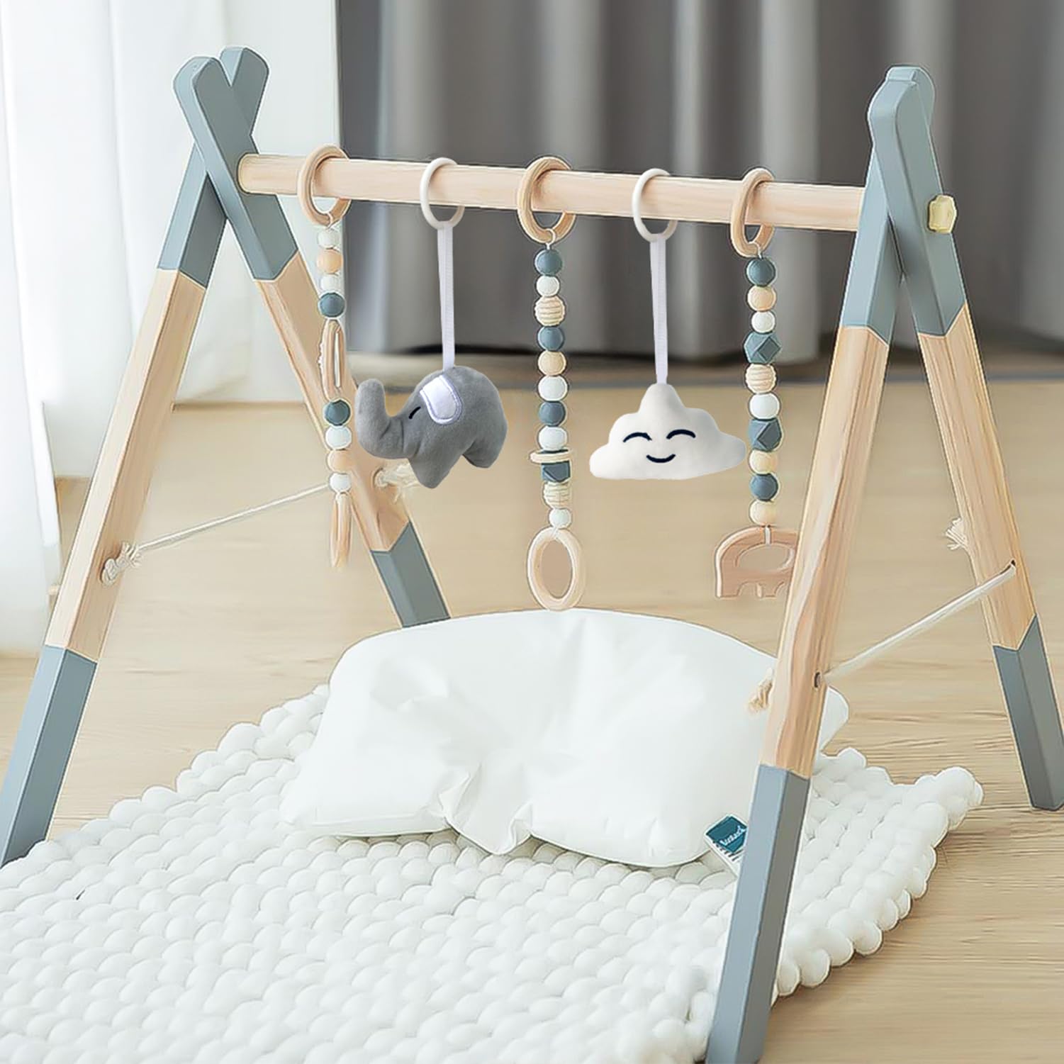 Avrsol newborn activity gym set up on a soft grey floor rug